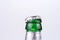 Bottleneck and open bottle cap of a green beer