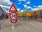 Bottleneck road narrowing speed limit sign