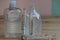Bottles of alcohol gel and syringes on wooden background