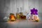 Bottles of aromatic oils with candles, pink orchid, stones and white towel on wooden background with vignette