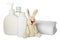Bottles of baby cosmetic products, towel and bunny toy on white background