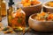 Bottles of calendula essential oil or infusion, wooden bowls and mortar of dried healthy calendula marigold flowers.