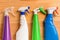 Bottles of cleaning detergents on wooden background