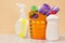 Bottles of dishwashing liquid, basket with garbage bags and brush on wooden desk