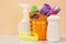 Bottles of dishwashing liquid, basket with garbage bags and sponges on wooden desk