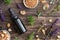 Bottles of essential oil with frankincense, tulsi, mountain savory and other herbs on wood