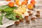 Bottles with essential oil, fresh apricots and pits on wooden table