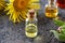 Bottles of essential oil with fresh elecampane plant