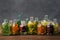 Bottles of essential oil or infusion of medicinal herbs and berries - rosemary, calendula, tansy, thuja, thyme, chamomile.