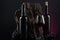 Bottles, glass of Spanish red wine and grapes on  wooden base on black and red background