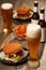 Bottles and glasses of beer with hamburgers