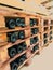 Bottles of good expensive wine lie horizontally on the wooden shelves of the cellar, in a warehouse, in a store