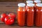 Bottles of homemade ketchup and tomatoes. tomato sauce