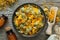 Bottles of homeopathic calendula granules, marigold flowers in bowl on wooden table. Top view. Homeopathy medicine