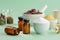 Bottles of homeopathic drugs, herbal and mineral ingredients and substances for preparation of homeopathic remedies on green.