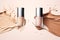 Bottles of makeup foundation and samples on beige background. Cosmetic product presentation. Luxury flying liquid in