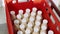 Bottles of milk puts in plastic box at milk factory, close-up