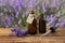 Bottles of natural essential oil, pipette and lavender flowers