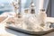 Bottles of perfume and cosmetics jar on tray, closeup. Luxury advertising photography. Generative AI