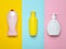 Bottles products for shower and bathroom on a multi-colored pastel background. Shampoo, liquid soap, shower gel. Top view.