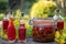 Bottles of red oil made from St. John`s wort flowers, outdoors