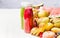 Bottles with red smoothies and juices beverages on white table background with summer fruits and berries, front view. Healthy food