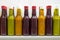 Bottles row with homemade sauces of oriental cuisine.