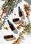 Bottles of sea buckthorn oil with a branch of sea buckthorn berries and a copy space.