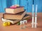 Bottles and syringes of vaccine aganist covid-19 near book pile and school supplies, back to school in coronavrus time concept