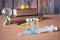 Bottles and syringes of vaccine aganist covid-19 near book pile and school supplies, back to school in coronavrus time concept