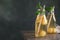 Bottles with tasty melon ball drink on table