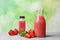 Bottles with tasty strawberry juice