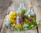 Bottles of tincture or infusion of healthy herbs on table.