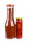 Bottles with tomato ketchup and chili peppers