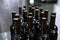 Bottles of wine without labels. Young wine is bottled. Craft winery. Large number of bottles of wine.