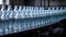 Bottling plant produces purified water in a row of transparent bottles generated by AI