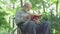 Bottom angle view of absorbed disabled senior man reading book and smiling. Intelligent handicapped Caucasian retiree