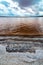 The bottom of the dried-up Kuyalnitsky estuary, covered with a layer of white self-precipitating table salt, clouds are reflected