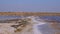 The bottom of a dying estuary, lake. Self-precipitating salt covers stones with a layer of white crystals, an environmental