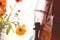 Bottom half of a violin with sheet music and flowers the front o