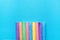 Bottom Row of Multicolored Chalks on Blue Background. Business Creativity Graphic Design Crafts Kids School Multiethnicity