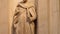 Bottom to top of a marble statue of a saint inside the cathedral of Siena