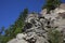 Bottom - to-top view of layers of stone against a blue sky.