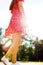 Bottom up view on young woman posing in red dress