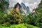 Bottom view of amazing steep cliffs among green woods and creeks