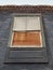 Bottom view of bricked up old window in dark gray concrete wall. Architecture and construction pattern