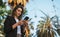 Bottom view-a cute businesswoman typing on a smartphone while standing in middle of a Park in city of Barcelona on summer day