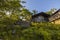 Bottom view of facade of typical wooden swedish house with wooden patio. Black walls and white windows with barbecue.