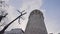 Bottom view of Galata Tower. Action. Ancient stone tower on background of blue sky. Historical stone tower in center of