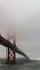 Bottom view of the Golden Gate Bridge in San Francisco in foggy and overcast weather, evening, strong wind. Concept, travel,